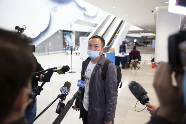 Zhongwu Qiu, an aircraft mechanic, talks to members of the media after arriving at LaGuardia Airport from Miami on the first Boeing 737 Max flight since the plane's return to service on Tuesday, Dec. 29, 2020, in New York. American Airlines is the first carrier to fly the newly certified 737. (Kevin Hagen/AP Photo).