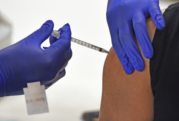 An employee of Wake Forest Baptist Medical Center receives one of the first COVID-19 vaccines at the medical center, in Winston-Salem, N.C., on Dec. 15, 2020 (Walt Unks/Winston-Salem Journal via AP)