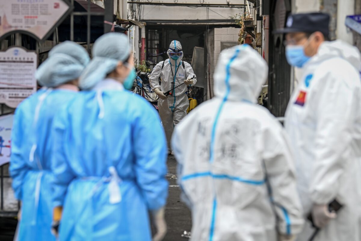 Health workers spray disinfectant in a blocked off area in Shanghai's Huangpu district, China, on Jan. 27, 2021. (AFP via Getty Images)