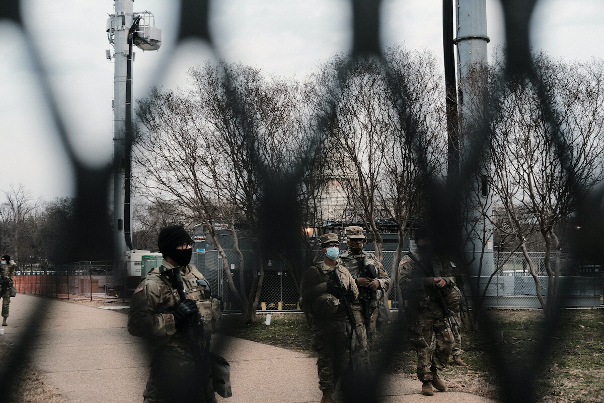 Members of the National Guard stand guard behind fences erected around the U.S. Capitol in Washington on Jan. 16, 2021. (Spencer Platt/Getty Images)