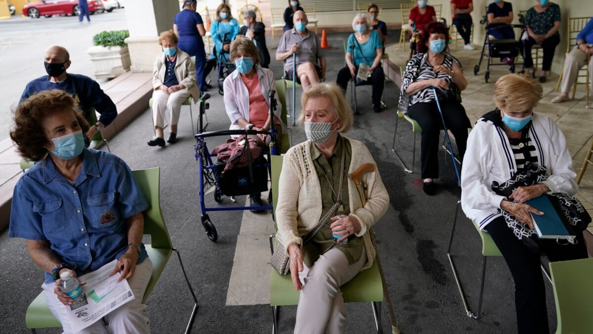 Residents wait to be cleared after receiving the Pfizer-BioNTech COVID-19 vaccine at The Palace assisted living facility in Coral Gables, Fla., on Jan. 12, 2021. (Lynne Sladky/AP Photo)