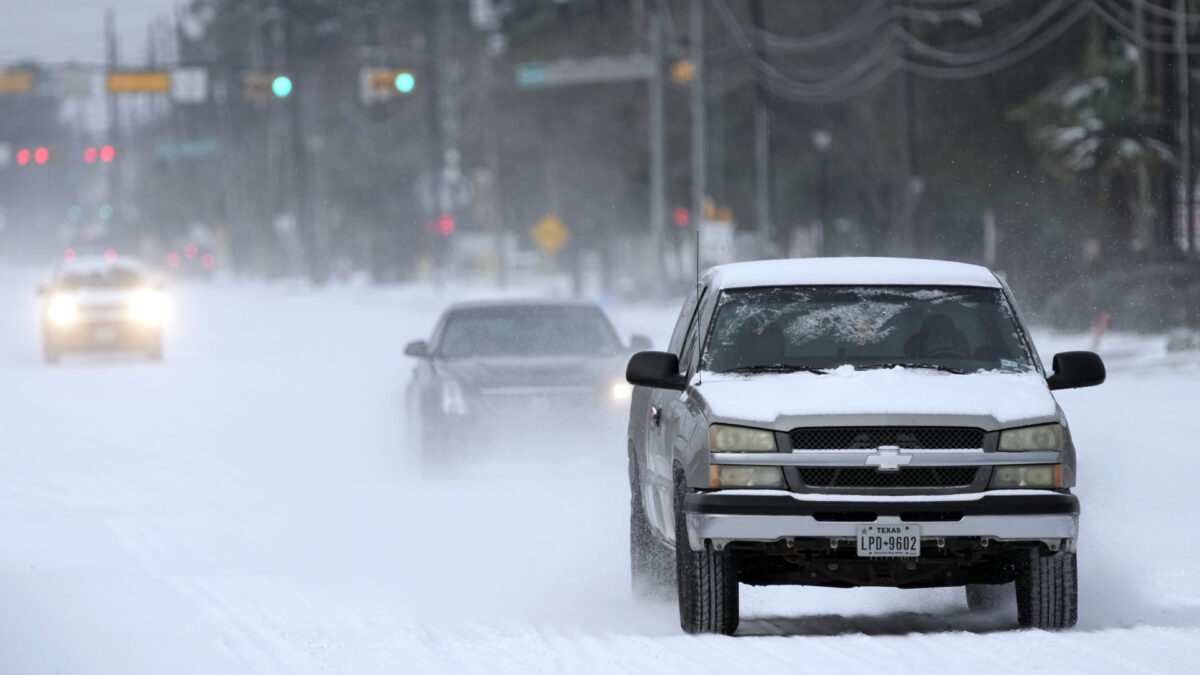 Vehicles drive on snow and sleet covered roads in Spring, Tex. on Feb. 15, 2021. (David J. Phillip/AP Photo)