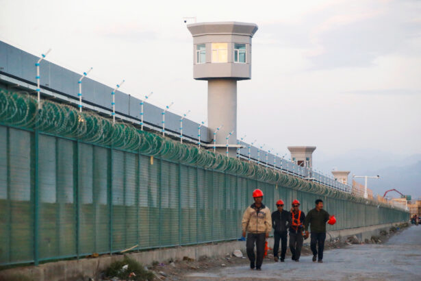 Workers walk by a vocational skills education centre