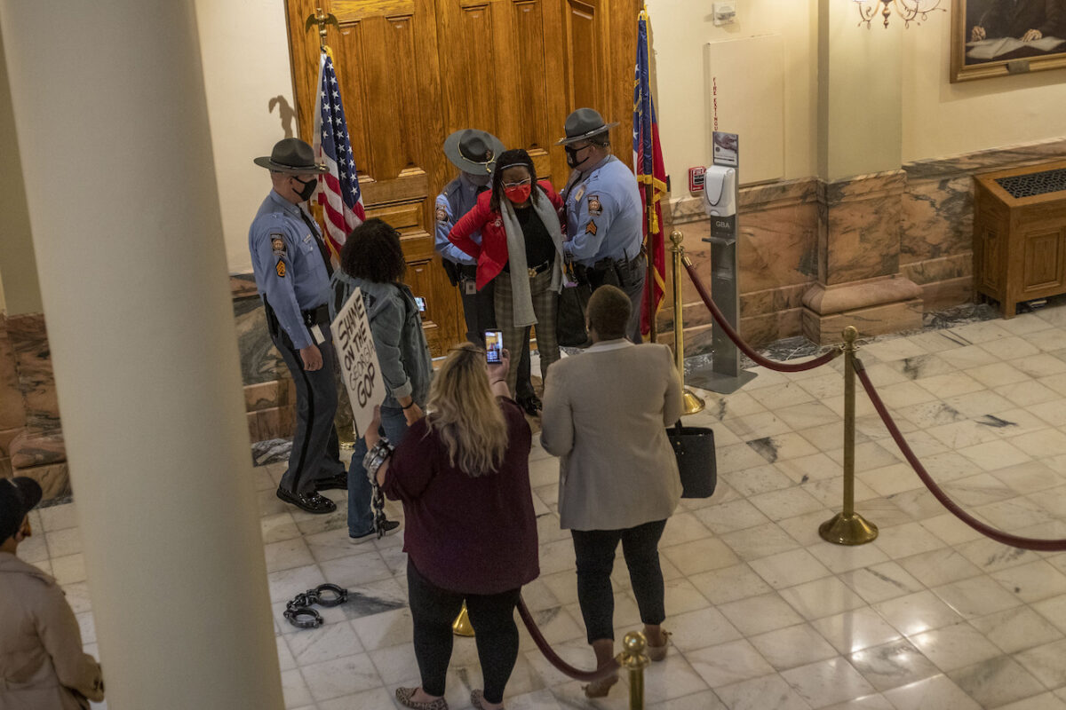 Rep. Park Cannon (D-Atlanta) is placed in handcuffs by Georgia State Troopers after being asked to stop knocking on a door that leads to Gov. Brian Kemp's office at the Georgia State Capitol Building in Atlanta, Ga., on March 25, 2021. (Alyssa Pointer/Atlanta Journal-Constitution via AP)