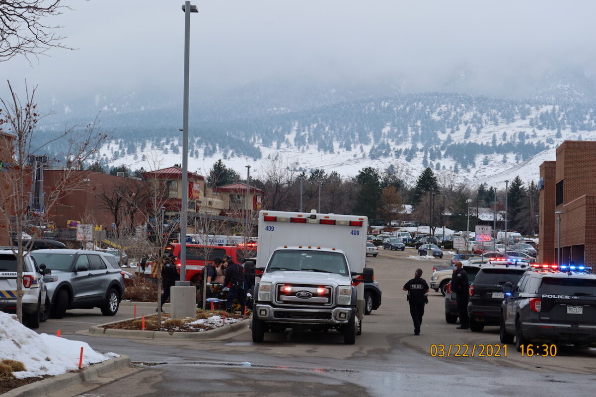 Police officers and an ambulance are seen at the scene where an active shooter was reported at a grocery store in Boulder, Colo., on March 22, 2021. (Cecil Disharoon/via Reuters)