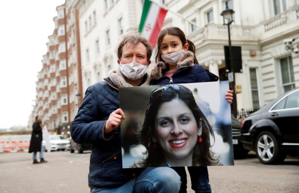 Richard Ratcliffe, husband of British-Iranian aid worker Nazanin Zaghari-Ratcliffe, and their daughter Gabriella protest outside the Iranian Embassy in London, England, on March 8, 2021. (Andrew Boyers/Reuters)