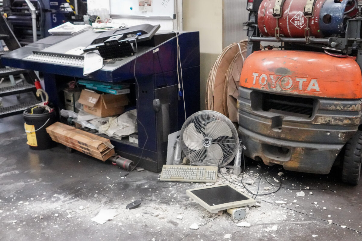 Damaged computers and construction debris on the floor at the print shop that prints the Hong Kong edition of The Epoch Times on April 12, 2021. (Adrian Yu/The Epoch Times)