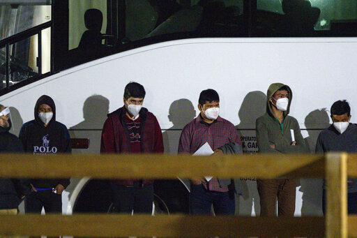 Unaccompanied minors wait to be processed after entering the site of a temporary holding facility south of Midland, Texas, on March 14, 2021. (Eli Hartman/Odessa American via AP)