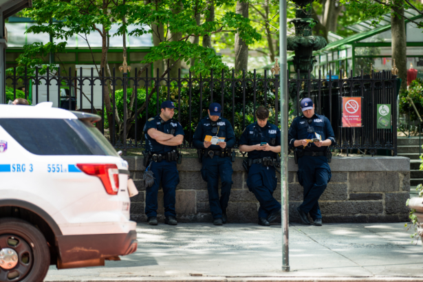 Bystanders watch a parade by practitioners of the spiritual discipline Falun Gong in New York on May 13, 2021. (Chung I Ho/The Epoch Times)