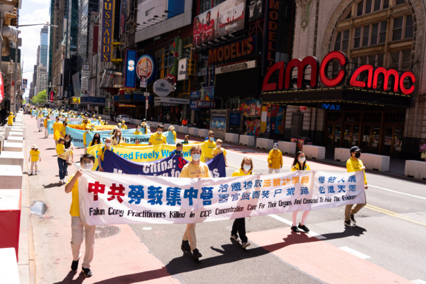 Practitioners of the spiritual discipline Falun Gong hold a parade in New York City on May 13, 2021. (Larry Dai/The Epoch Times)