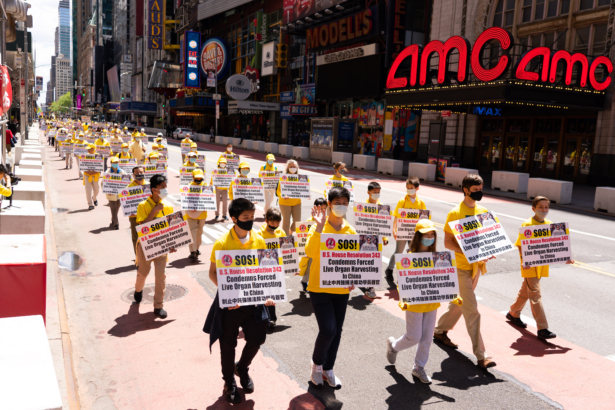 Practitioners of the spiritual discipline Falun Gong hold a parade in New York to celebrate World Falun Dafa Day and to protest the ongoing persecution of the group by the Chinese Communist Party in China, on May 13, 2021. (Larry Dai/The Epoch Times)