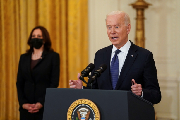President Joe Biden delivers remarks as Vice President Kamala Harris stands by in the East Room at the White House in Washington, on May 10, 2021. (Kevin Lamarque/Reuters)