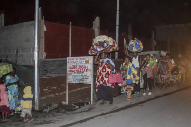 People flee with their belongings after the eruption of Mount Nyiragongo, in Goma, Congo, on May 22, 2021. (Justin Kabumba/AP Photo)