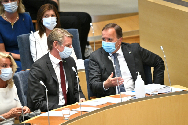 Sweden's Prime Minister Stefan Lofven (R) speaks with Minister for Environment and Climate Per Bolund before the no-confidence vote at the Swedish parliament, in Stockholm, Sweden, on June 21, 2021. (TT News Agency/Claudio Bresciani via Reuters)
