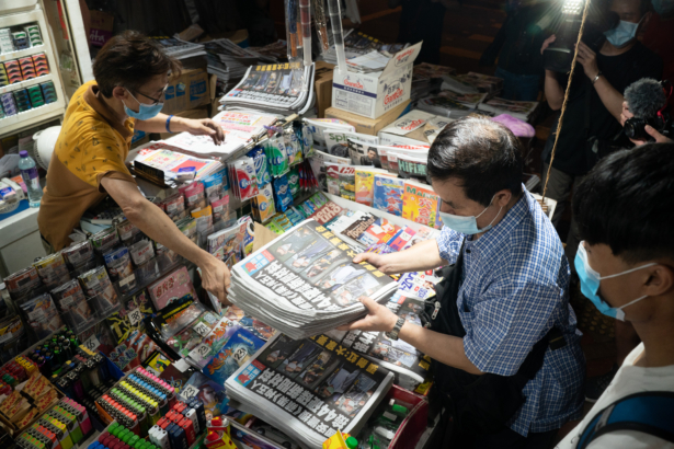 A man buys multiple copies of the latest Apple Daily newspaper in Hong Kong, on June 18, 2021. (Anthony Kwan/Getty Images)