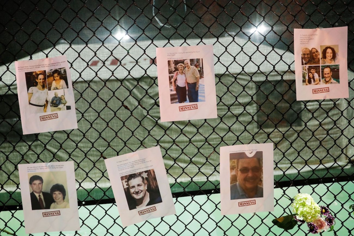 Pictures of missing people and flowers hang on a fence at the memorial for victims of a partially collapsed residential building as the emergency crews continue search and rescue operations for survivors, in Surfside, near Miami Beach, Fla., on June 25, 2021. (Octavio Jones/Reuters)