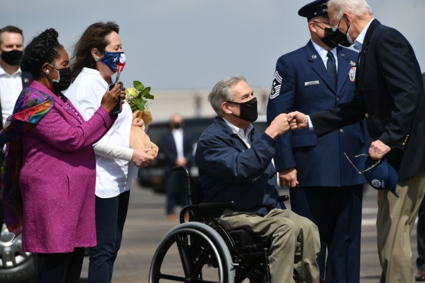 President Joe Biden (R) greets Texas Governor Greg Abbott and his wife Cecilia Abbott (2nd-L) at Ellington Field Joint Reserve Base in Houston, Texas, on Feb. 26, 2021. (Mandel Ngan/AFP via Getty Images)