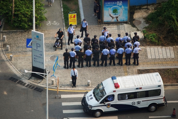 Police officers and security personnel gather outside the headquarters of China Evergrande Group in Shenzhen, Guangdong province, China, on Sept. 30, 2021. (Aly Song/Reuters)