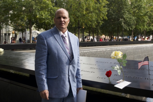 Eddie Bracken, leaving a letter and flowers for his sister at World Trade Center memorial site, in Manhattan, New York, on Sep. 10, 2021 (Enrico Trigoso/The Epoch Times)