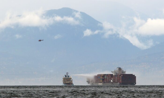 Ships work to control a fire onboard the MV Zim Kingston about 8 kilometers (5 miles) from the shore in Victoria, British Columbia, Canada, on Oct. 24, 2021. (Chad Hipolito/The Canadian Press via AP)