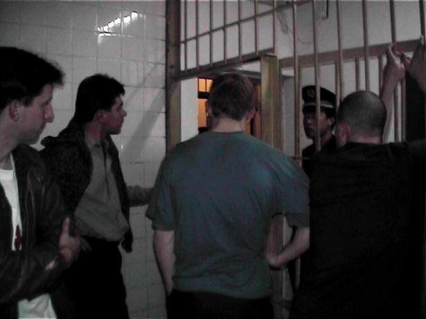 European Falun Gong practitioners talk to a policeman from inside the underground jail in a police station near Tiananmen Square in Beijing, China, on Nov. 20, 2001. (Courtesy of Adam Leining)