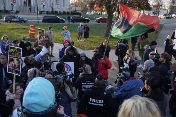 Justin Blake, Jacob Blake's Uncle, waves a UNIA flag at a march protesting Kyle Rittenhouse's acquittal by jury in Kenosha, Wis., on Nov. 21, 2021. (Jackson Elliott/The Epoch Times)