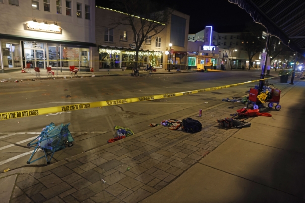 Police tape cordons off a street in Waukesha, Wis., after an SUV plowed into a Christmas parade hitting multiple people on Nov. 21, 2021. (Jeffrey Phelps/AP Photo)
