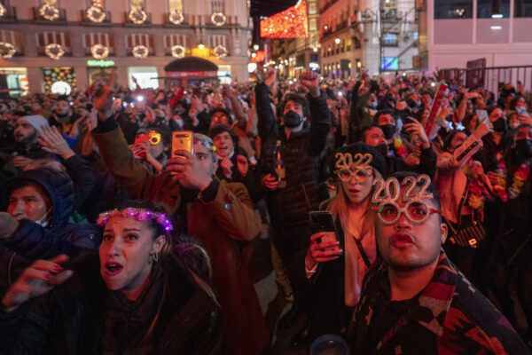 People celebrate during New Year's celebrations at Madrid's Puerta del Sol in downtown Madrid, Spain, on Jan. 1, 2022. (Manu Fernandez/AP Photo)