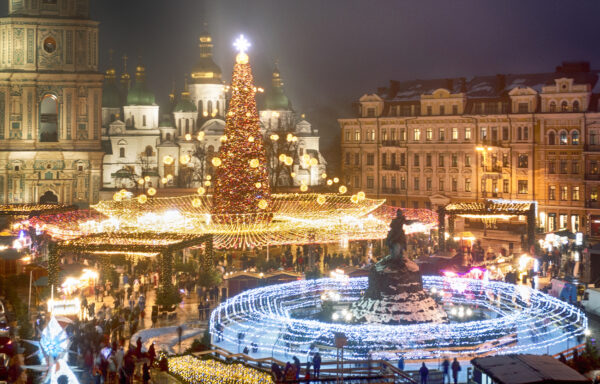Crowds of people celebrate the New Year around the Christmas tree with the St. Sofia Cathedral in the background in Kyiv, Ukraine, on Dec. 31, 2021. (Efrem Lukatsky/AP Photo)