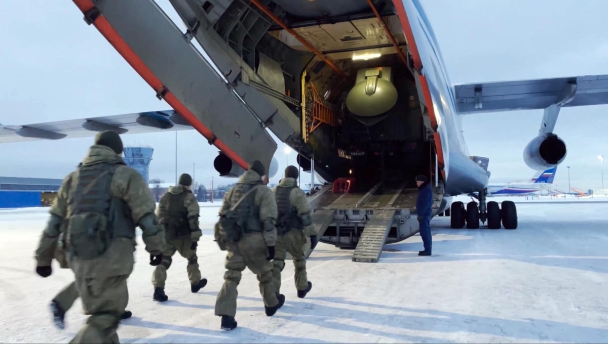 In this photo taken from a video released by the Russian Defense Ministry Press Service, Russian peacekeepers board on a Russian military plane at an airfield outside Moscow, in Russia to fly to Kazakhstan on Jan. 6, 2022. (Russian Defense Ministry Press Service via AP)