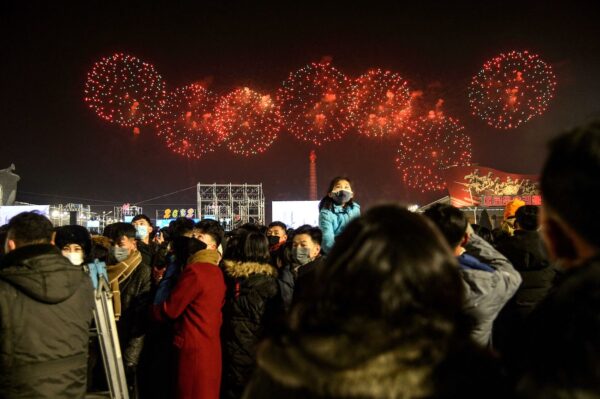 People gather to watch a firework display to celebrate the new year on Kim Il Sung Square in Pyongyang on Jan. 1, 2022. (Kim Won Jin/AFP via Getty Images)