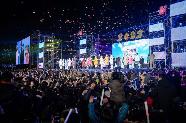 People watch as performers take part in a new year performance on Kim Il Sung Square in Pyongyang late on Dec. 31, 2021. (Kim Won Jin/AFP via Getty Images)