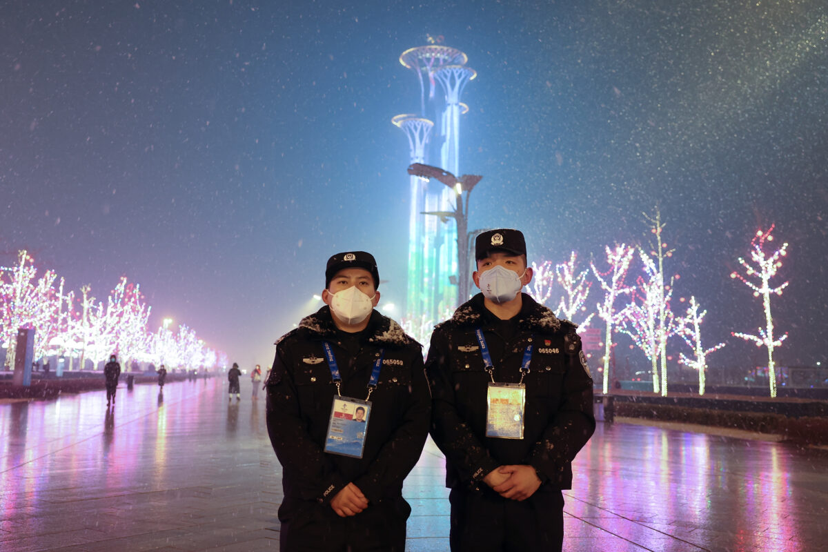 Two Chinese police wears a protective mask as they stands in front of the Olympic Tower ahead of the Beijing Winter Olympics in Beijing, China, on Jan. 30, 2022. (Lintao Zhang/Getty Images)