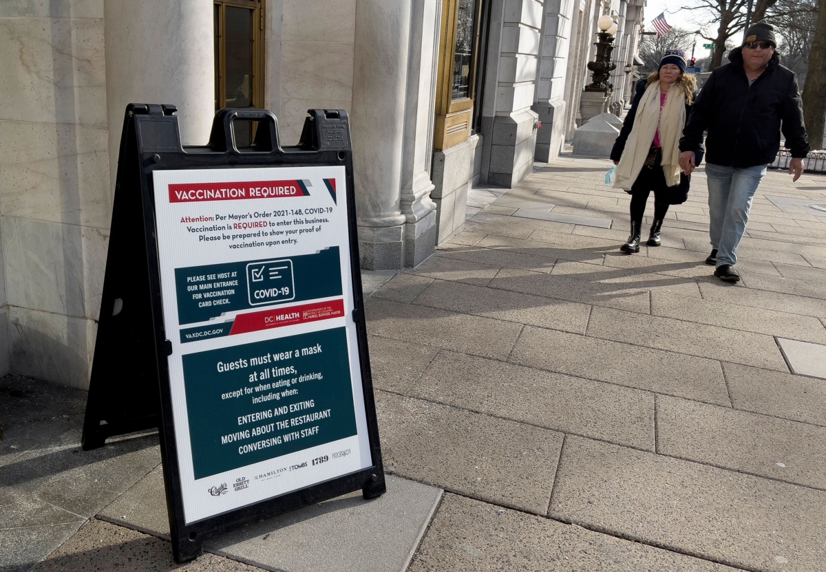 A sign requiring proof of vaccination for guests is posted outside a restaurant in downtown Washington on Jan. 19, 2022. (Daniel Slim/AFP via Getty Images)