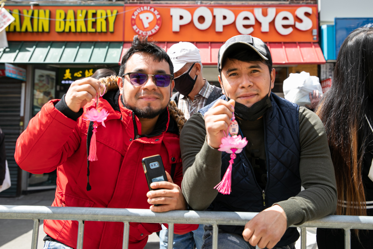 Bystanders join Falun Gong practitioners in a parade to commemorate the 23rd anniversary of the April 25th peaceful appeal of 10,000 Falun Gong practitioners in Beijing, in Flushing, New York, on April 23, 2022. (Chung I Ho/The Epoch Times)