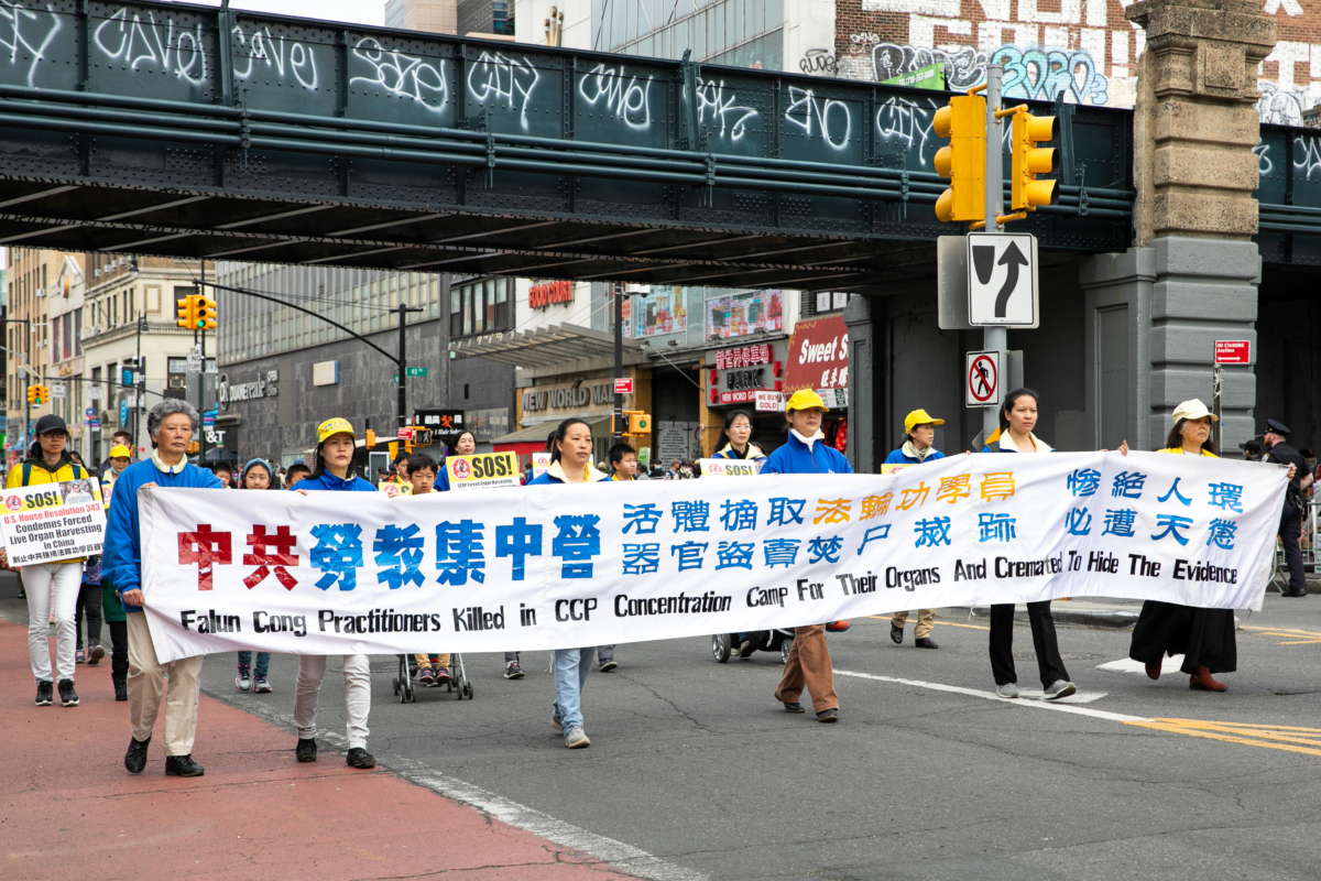 Falun Gong practitioners participate in a parade to commemorate the 23rd anniversary of the April 25th peaceful appeal of 10,000 Falun Gong practitioners in Beijing, in Flushing, New York, on April 23, 2022. (Chung I Ho/The Epoch Times)