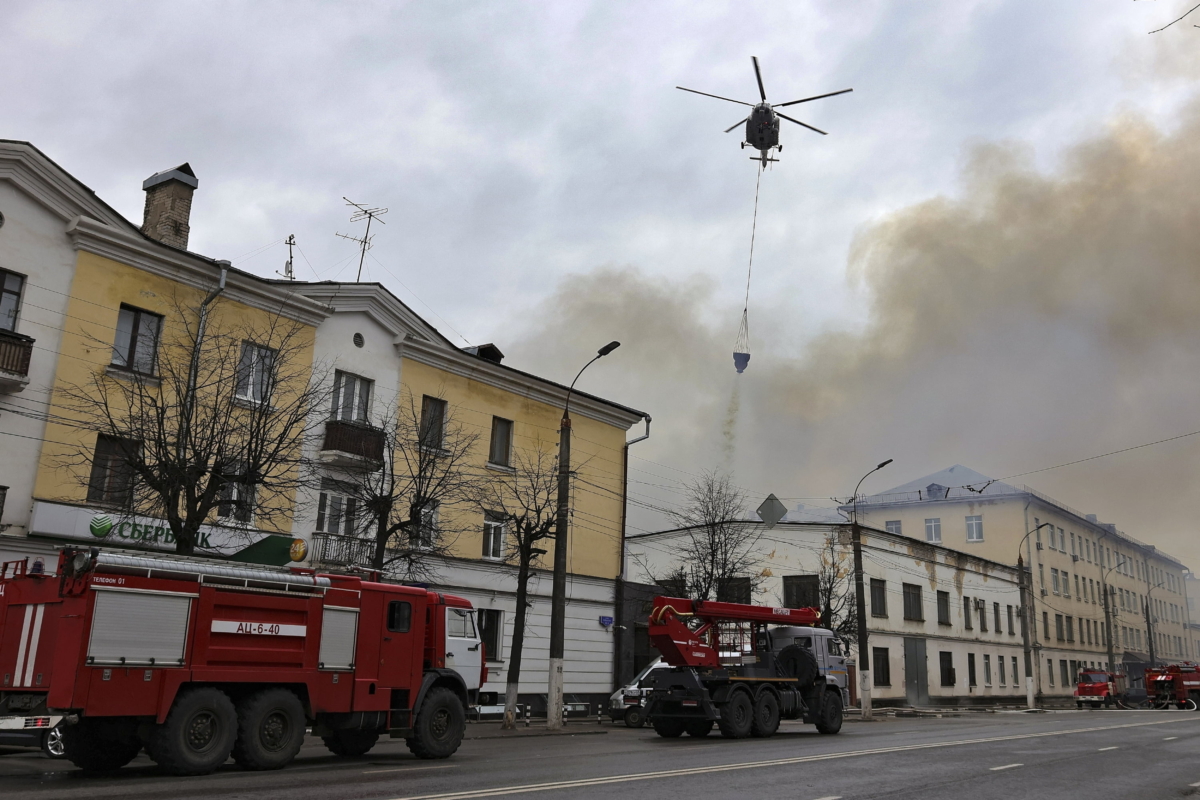 A helicopter dumps water onto the burning building of the Central Research Institute of the Aerospace Defense Forces in the Russian city of Tver, Russia, on April 21, 2022. (Vitaliy Smolnikov/Kommersant Publishing House via AP)
