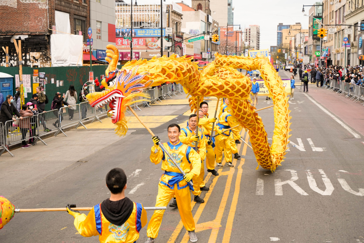 Falun Gong practitioners participate in a parade to commemorate the 23rd anniversary of the April 25th peaceful appeal in Beijing, in Flushing, New York, on April 23, 2022. (Larry Dye/The Epoch Times)