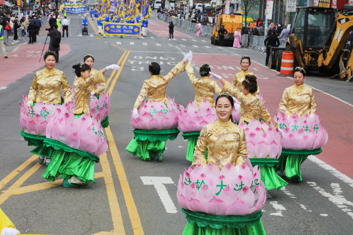 Falun Gong practitioners participate in a parade to commemorate the 23rd anniversary of the April 25th peaceful appeal of 10,000 Falun Gong practitioners in Beijing, in Flushing, New York, on April 23, 2022. (Zhang Xuehui/The Epoch Times)