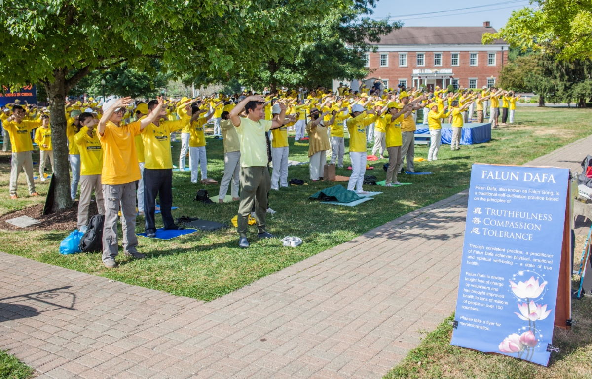 Falun Gong adherents practice meditative exercises in a park in Goshen., N.Y., on July 17, 2022. A few hundred adherents of the spiritual practice gathered in the park to commemorate 23 years since the Chinese Communist Party launched a persecution of their fellows in faith in China. (Petr Svab/The Epoch Times)