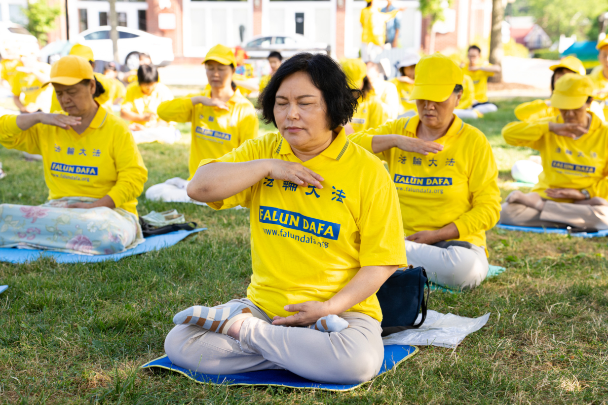 Falun Gong adherents meditate in a park in Goshen., N.Y., on July 17, 2022. A few hundred adherents of the spiritual practice gathered in the park to commemorate 23 years since the Chinese Communist Party launched a persecution of their fellows in faith in China. (Larry Dye/The Epoch Times)