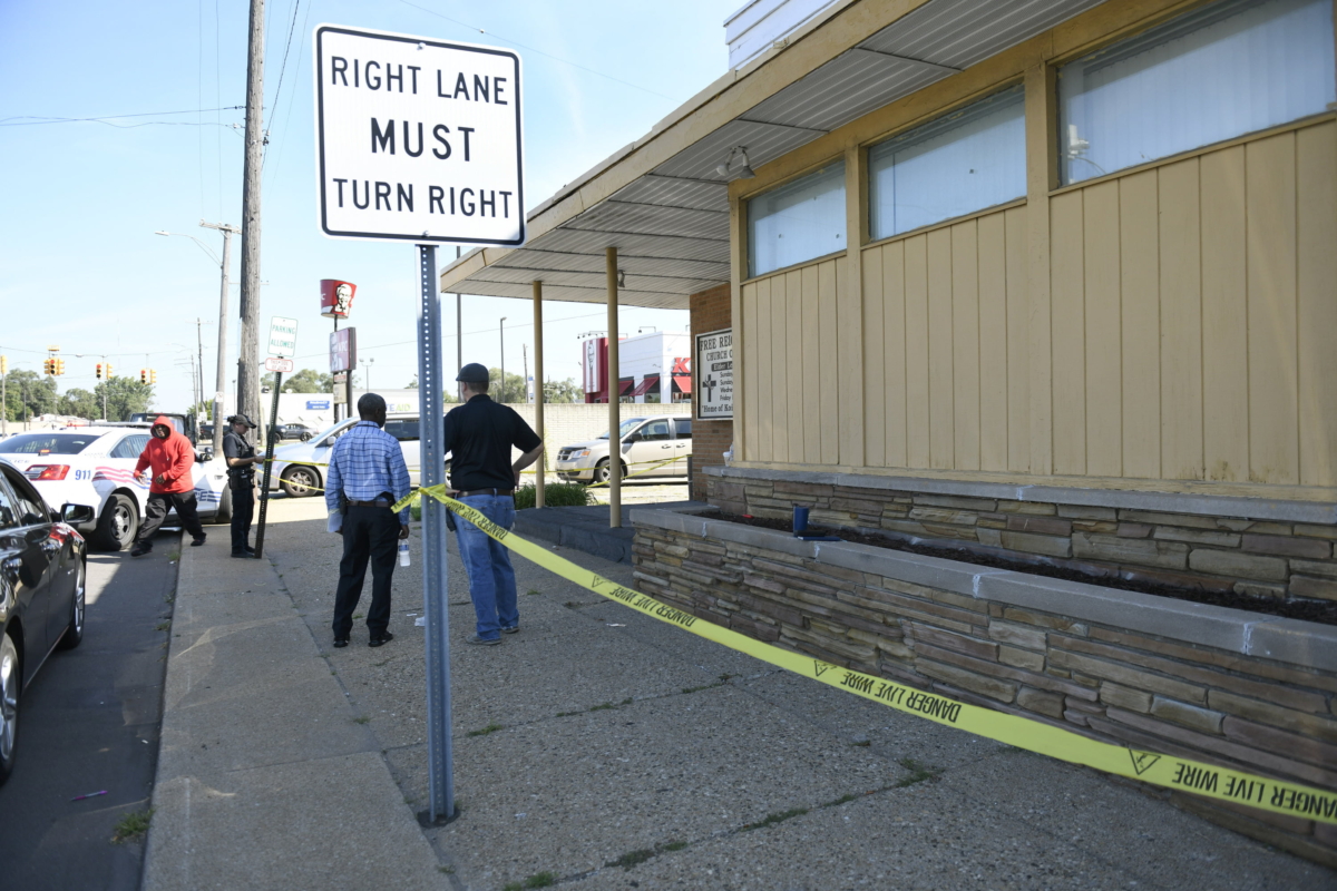 Detroit Police and investigators look over a homicide scene on Wyoming Avenue, near the corner of Seven Mile Road, in Detroit on Aug. 28, 2022. (Jose Juarez/Special to Detroit News via AP)