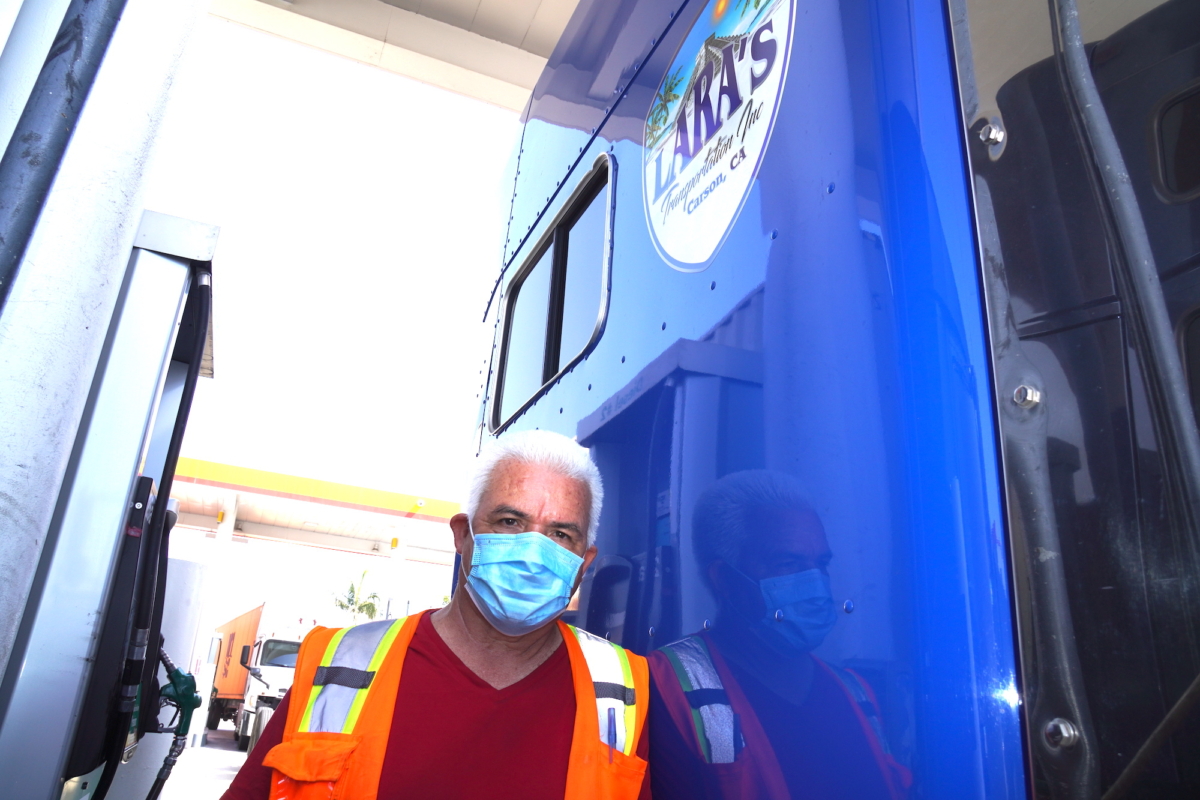 Independent truck owner-operator Efraim Lara fills his big rig with gas at a truck stop in Long Beach, Calif., on July 26, 2022. Lara said California's new labor law could put him out of business. (Allan Stein/The Epoch Times)