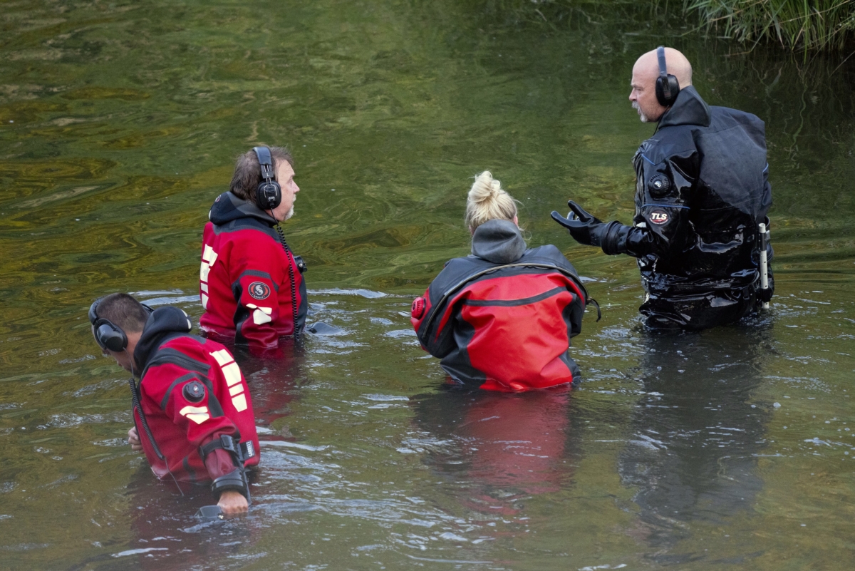 Water Recovery authorities comb the Apple River with metal detectors after five people were stabbed while tubing down the river in Somerset, Wis., on July 30, 2022. (Alex Kormann/Star Tribune via AP)