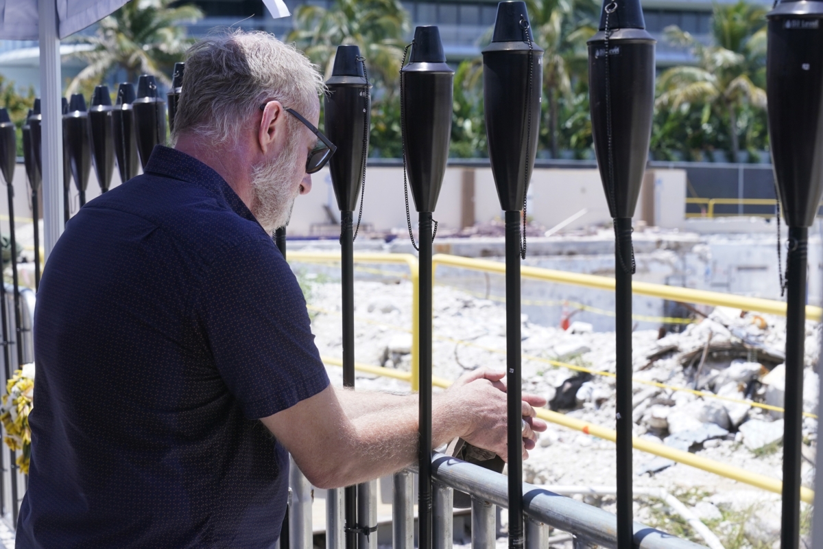 An attendee at a remembrance event at the site of the Champlain Towers South building collapse, takes a moment as he looks out at the area where the building once stood, in Surfside, Fla., on June 24, 2022. (Wilfredo Lee/AP Photo)