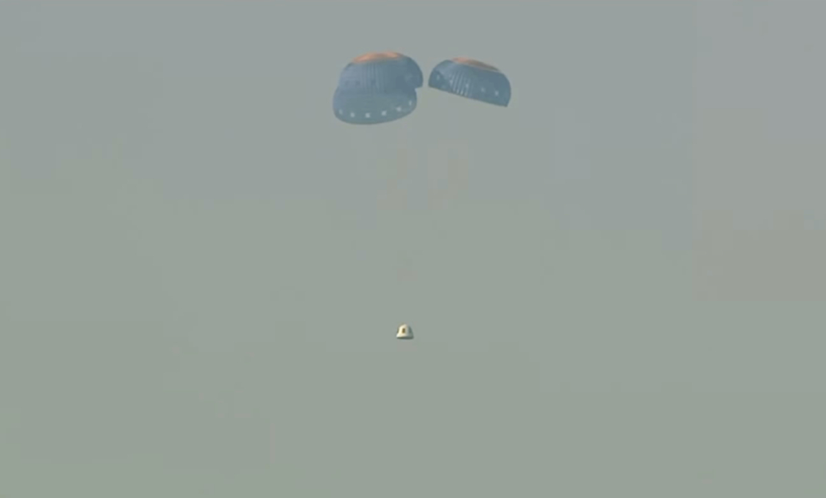 A capsule, containing science experiments after a launch failure, parachutes onto the desert floor on Sept. 12, 2022. (Blue Origin via AP)