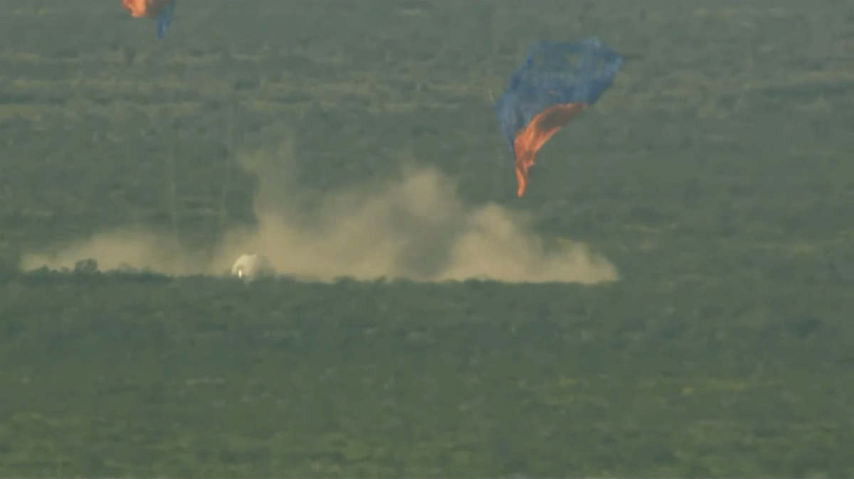 A capsule, containing science experiments after a launch failure, parachutes onto the desert floor on Sept. 12, 2022. (Blue Origin via AP)
