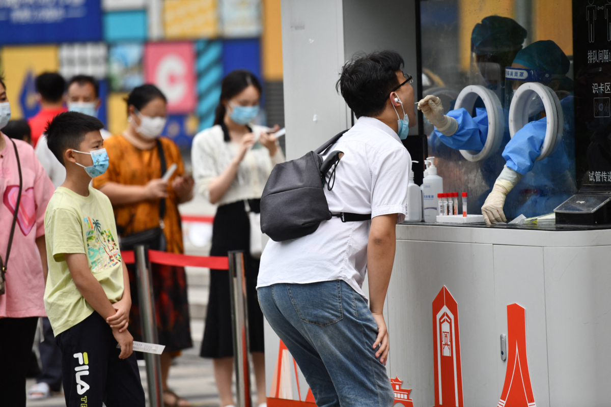 A health worker takes a swab sample from a man to be tested for the COVID-19 coronavirus in Chengdu, in China's southwestern Sichuan province on Sept. 1, 2022. (AFP via Getty Images)