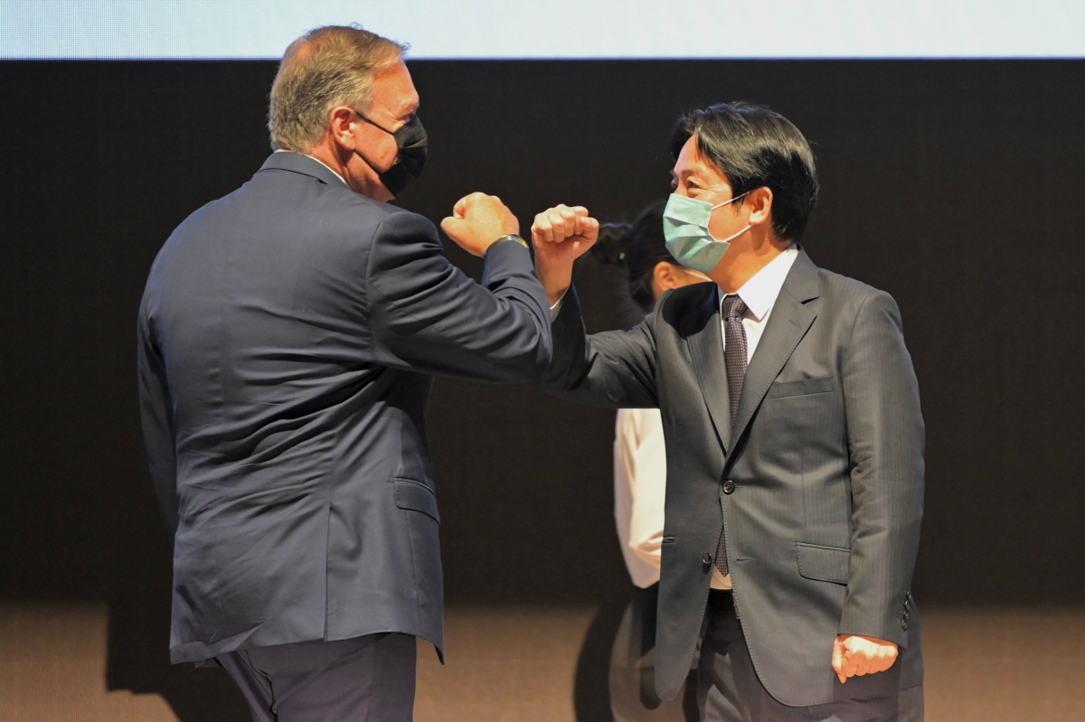 Taiwan's Vice President William Lai (R) bumps elbows with former U.S. Secretary of States Mike Pompeo during the Global Taiwan Business Forum in Kaohsiung, Taiwan, on Sept. 27, 2022. (Sam Yeh/AFP via Getty Images)