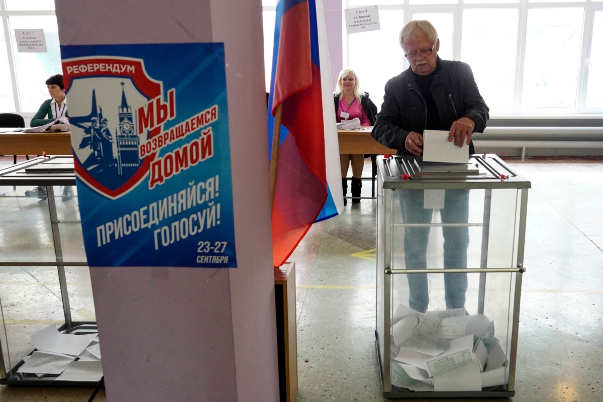 A man casts his ballot for a referendum at a polling station in Mariupol, Ukraine, on Sept. 27, 2022. (Stringer/AFP via Getty Images)